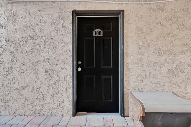 entrance to property with stucco siding