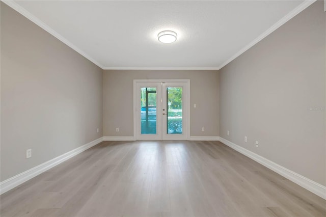 unfurnished room featuring ornamental molding, light hardwood / wood-style flooring, and french doors