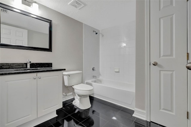 full bathroom featuring tile patterned flooring, a textured ceiling, tiled shower / bath combo, toilet, and vanity