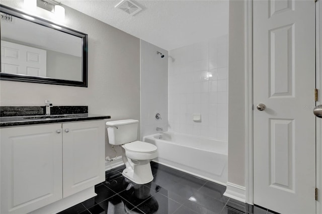 bathroom featuring toilet, vanity, visible vents, baseboards, and  shower combination