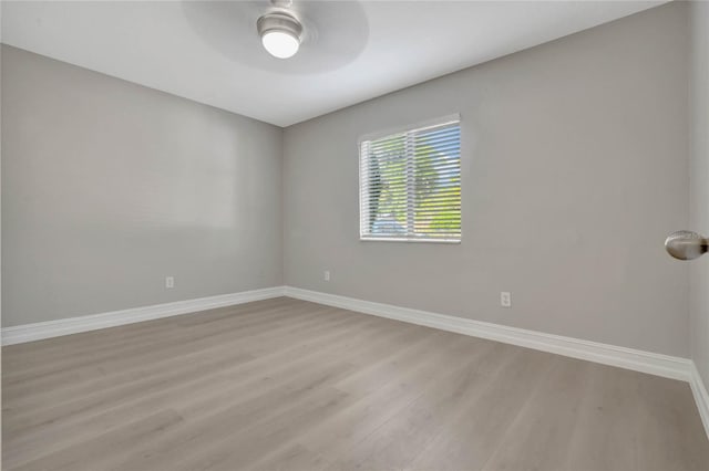 spare room featuring hardwood / wood-style flooring and ceiling fan