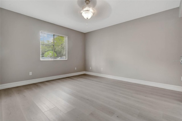 spare room featuring hardwood / wood-style flooring and ceiling fan