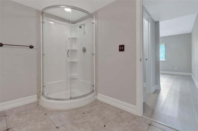 bathroom with tile patterned flooring and walk in shower