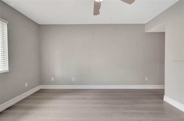 unfurnished room with wood-type flooring and ceiling fan