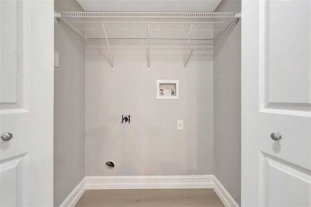 laundry room featuring electric dryer hookup, hardwood / wood-style floors, and washer hookup