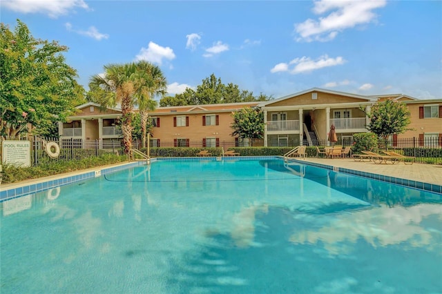 pool featuring fence and stairway