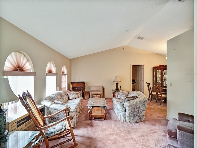 living room featuring lofted ceiling and carpet