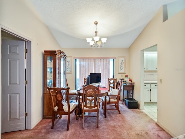 dining space featuring vaulted ceiling, a textured ceiling, a notable chandelier, and tile patterned floors