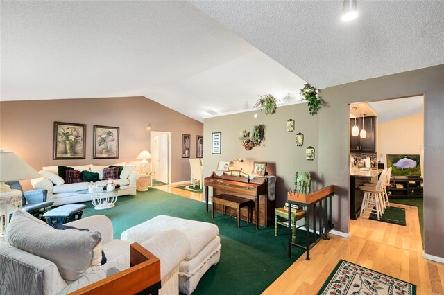 living room featuring light hardwood / wood-style flooring, a textured ceiling, and lofted ceiling