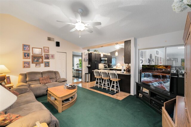 living room featuring ceiling fan, light wood-type flooring, and lofted ceiling