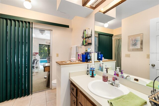 bathroom featuring vanity, tile patterned flooring, and toilet