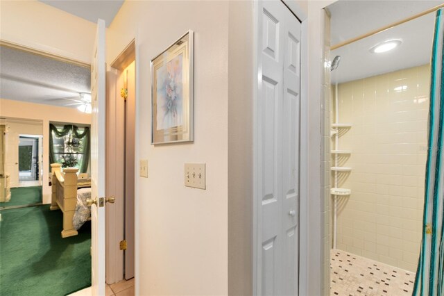 bathroom featuring ceiling fan and curtained shower