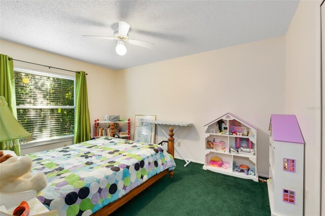 carpeted bedroom featuring ceiling fan and a textured ceiling