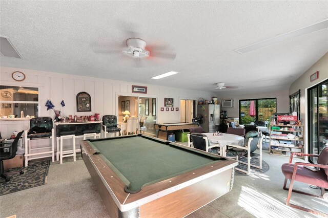 recreation room with ceiling fan, pool table, and a textured ceiling