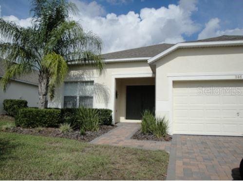 view of exterior entry with a garage