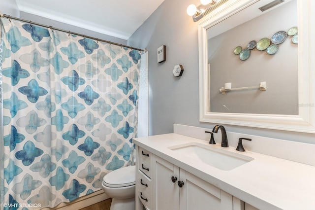 bathroom with vanity, toilet, visible vents, and a shower with curtain