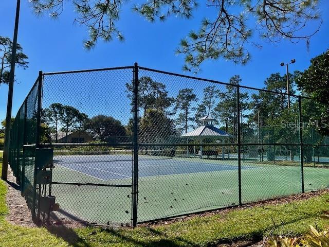 view of tennis court featuring fence