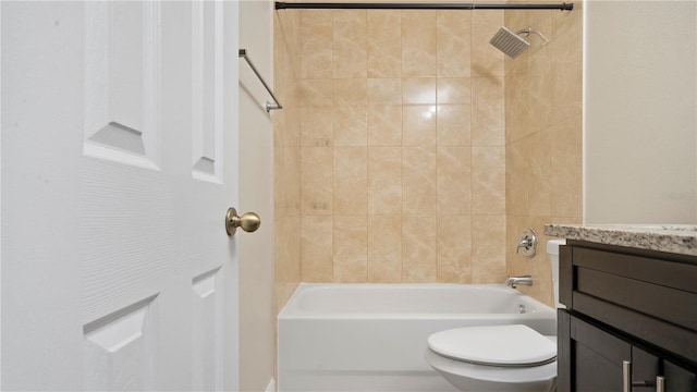 full bathroom featuring vanity, tiled shower / bath combo, and toilet