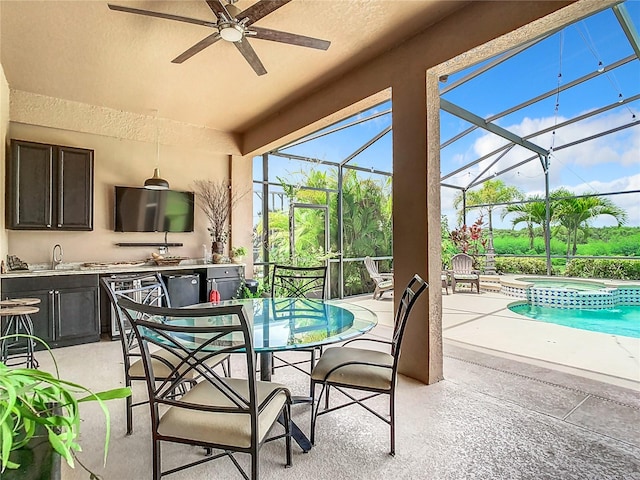 sunroom featuring sink and ceiling fan