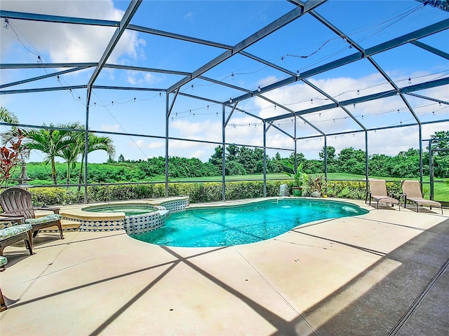 view of swimming pool featuring an in ground hot tub, glass enclosure, and a patio area