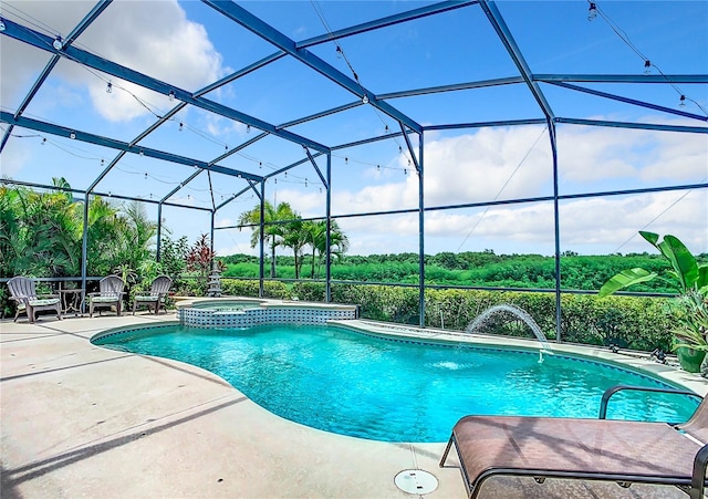 view of pool with an in ground hot tub, a patio, pool water feature, and glass enclosure