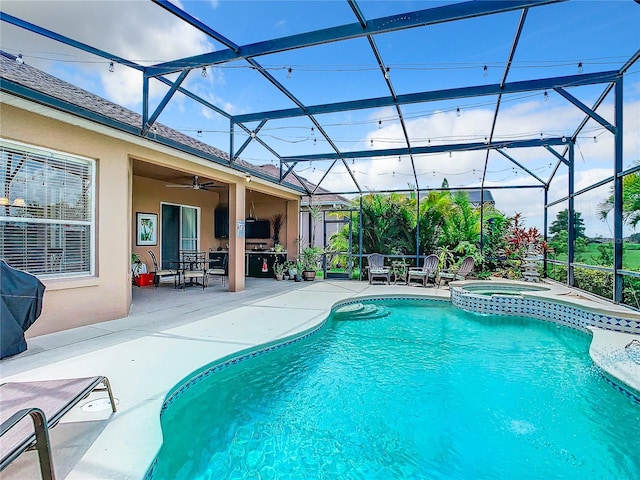 view of swimming pool featuring an in ground hot tub, a lanai, a patio, and ceiling fan