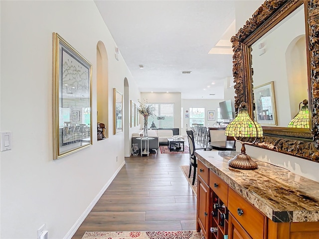 corridor featuring dark hardwood / wood-style floors