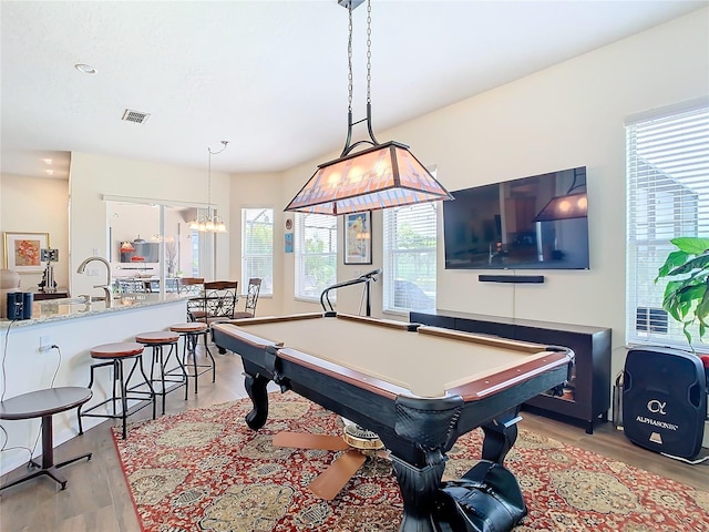 rec room with light hardwood / wood-style flooring and billiards