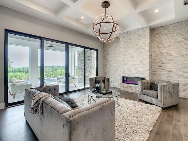 living room with coffered ceiling, a healthy amount of sunlight, and wood-type flooring