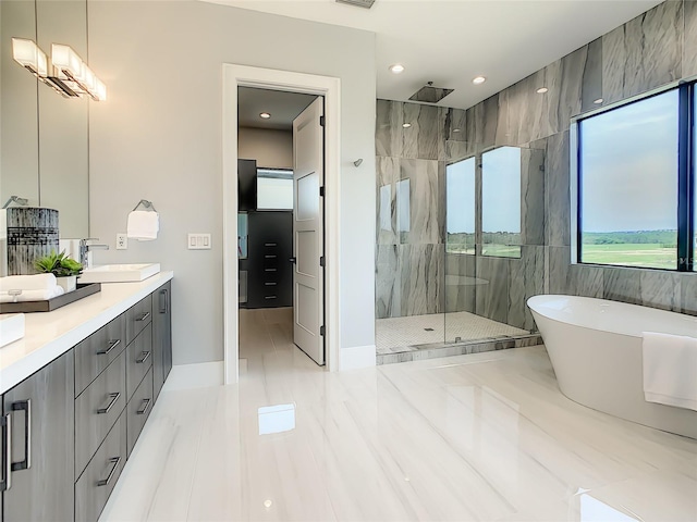 bathroom featuring tile patterned flooring, tile walls, plus walk in shower, and dual vanity