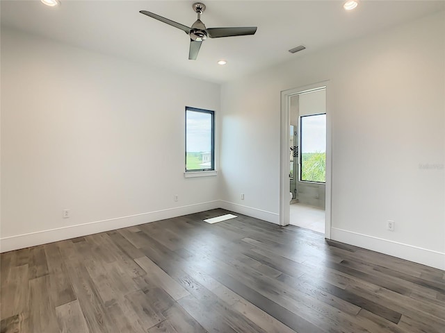 empty room with ceiling fan and dark hardwood / wood-style floors