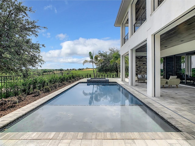 view of swimming pool featuring a patio and an outdoor hangout area