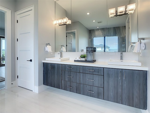 bathroom with tile patterned flooring and dual bowl vanity