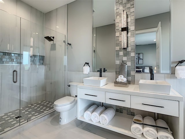 bathroom with vanity, tile patterned flooring, an enclosed shower, tile walls, and toilet