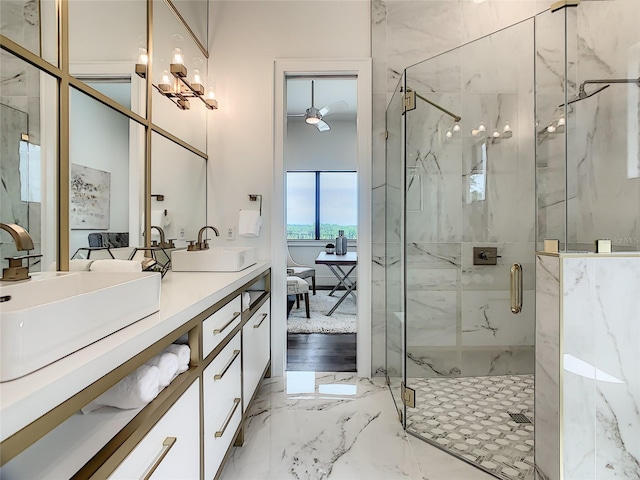 bathroom featuring double vanity, ceiling fan with notable chandelier, a shower with door, and hardwood / wood-style floors