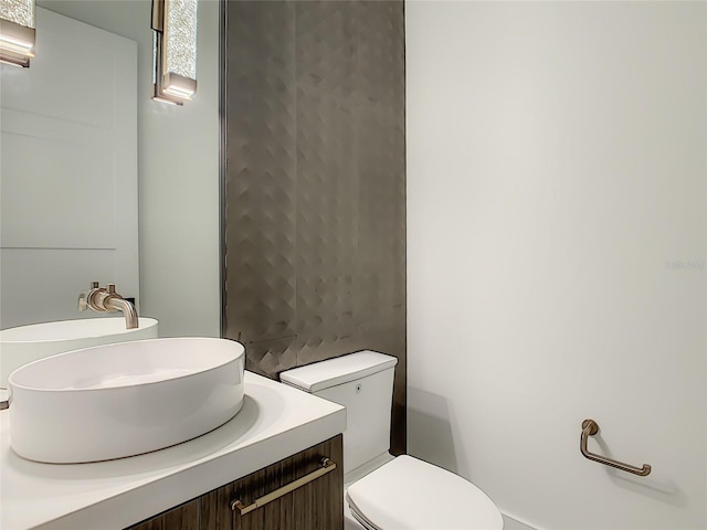 bathroom with toilet and vanity