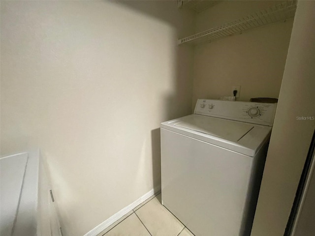1073 S Hiawassee Rd Unit 1018, Orlando, FL 32835 - laundry room featuring light tile patterned floors, laundry area, washer / dryer, and baseboards