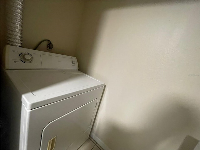 1073 S Hiawassee Rd Unit 1018, Orlando, FL 32835 - washroom featuring light tile patterned floors, laundry area, and washer / clothes dryer