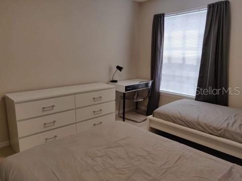 1073 S Hiawassee Rd Unit 1018, Orlando, FL 32835 - bedroom featuring baseboards