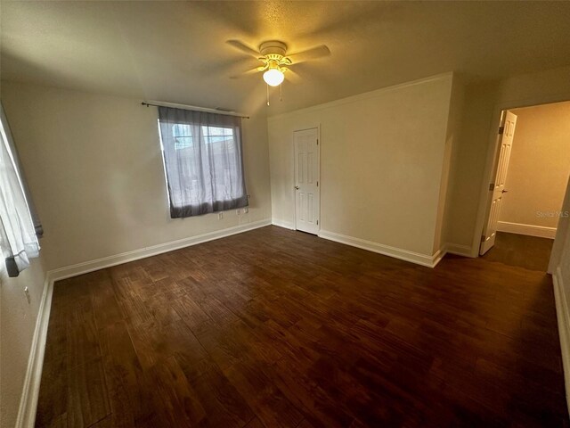 unfurnished bedroom with ceiling fan and dark hardwood / wood-style floors