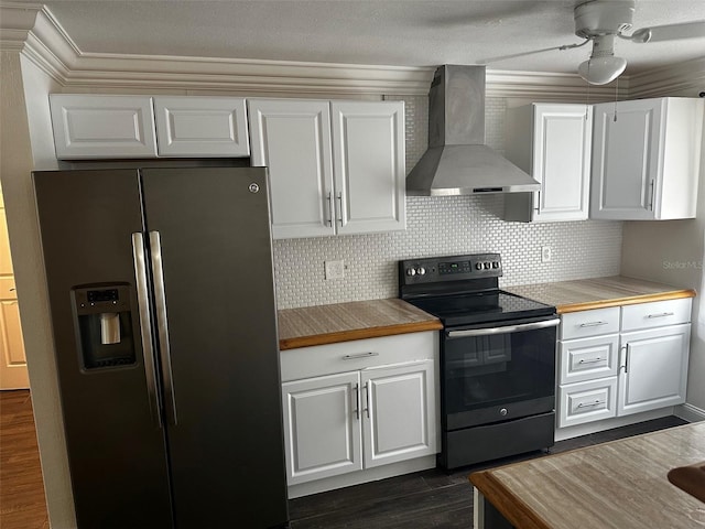 kitchen with white cabinetry, wall chimney exhaust hood, stainless steel fridge with ice dispenser, ceiling fan, and black range with electric cooktop