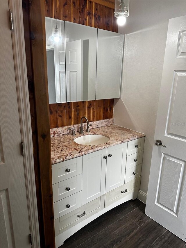 bathroom with vanity and wood-type flooring