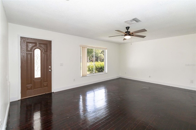 foyer with hardwood / wood-style flooring, a textured ceiling, and ceiling fan