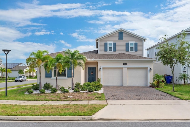 view of front of home featuring a front lawn and a garage