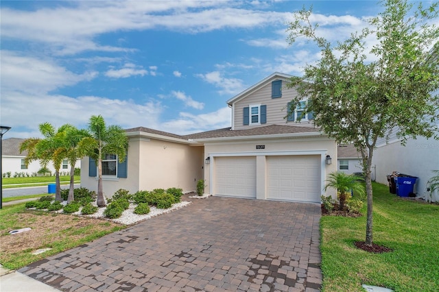 view of front of property with a garage and a front lawn