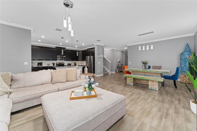 living room with ornamental molding and light wood-type flooring