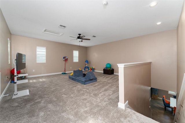 workout room with ceiling fan and carpet flooring