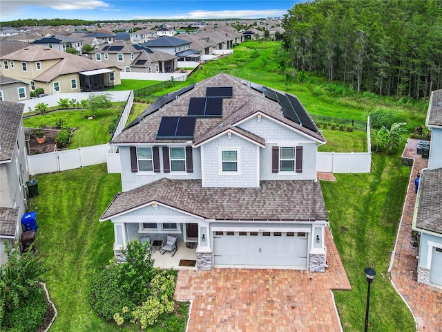 view of front of property featuring solar panels, central air condition unit, and a garage