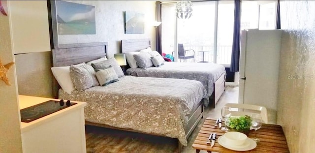 bedroom with a notable chandelier and hardwood / wood-style floors