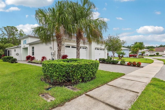 view of front of property with a garage and a front yard